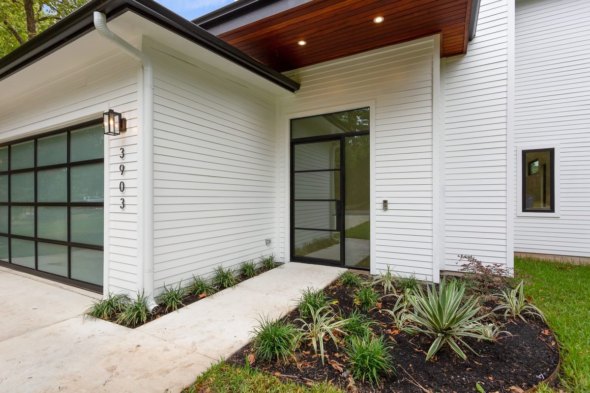 Covered front entry with wood ceiling and glass door