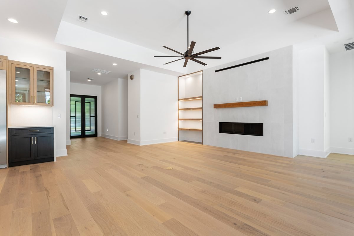 Living room with tiled fireplace and built-in shelving